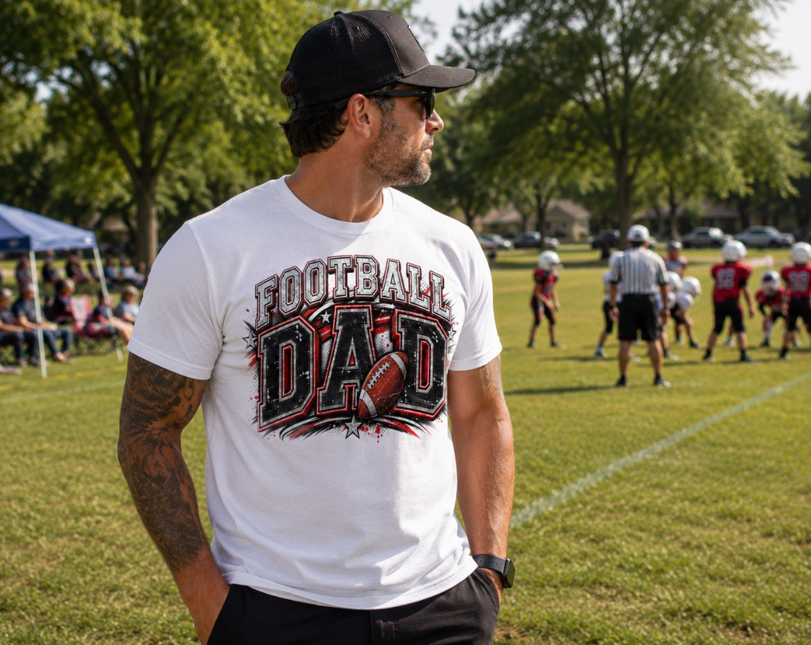 Football Dad black graphic tee with burst design and script lettering worn at youth football game